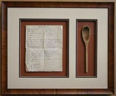 an old letter and spoon are framed in a frame