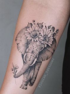 an elephant with sunflowers on it's head is shown in black and white