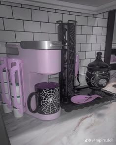 a kitchen counter topped with purple and black items