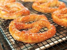 several pretzels sitting on a cooling rack ready to be baked in the oven