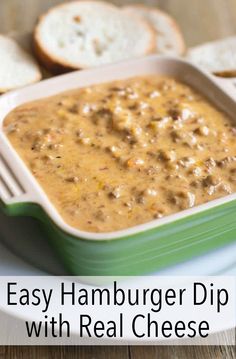 an easy hamburger dip with real cheese in a green and white dish on a plate