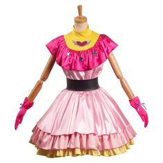 a pink and yellow dress on a mannequin's head with red gloves