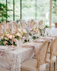 the table is set with white and pink flowers