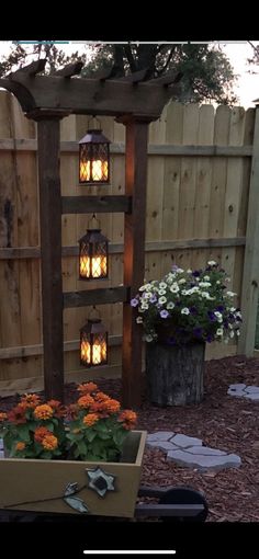 an outdoor area with flowers and lights in the background, along with a wooden trellis