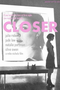 a woman standing in front of a large screen with the words closer on it's side