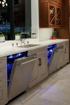 a kitchen that has some lights on the side of it and cabinets in front of it