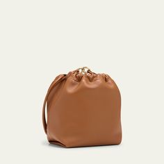 Valentino Garavani bucket bag in soft lambskin leather Shoulder strap with VLOGO accent  Drawstring and clasp closure  Interior, slip pocket Lining: Leather Approx. 10.2"H x 13.4"W x 3.9"D Made in Italy Formal Cognac Bucket Shoulder Bag, Formal Cognac Shoulder Bucket Bag, Elegant Cognac Bucket Bag For Formal Occasions, Versatile Brown Bucket Bag For Evening, Elegant Bucket Pouch, Elegant Cognac Bucket Bag With Soft Leather, Brown Crossbody Bucket Bag For Evening, Evening Cognac Bucket Bag With Detachable Strap, Leather Bucket Pouch For Shopping