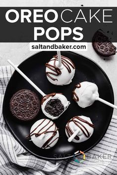 oreo cake pops on a black plate with white chocolate drizzle