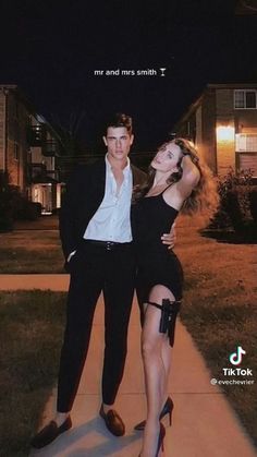 a man and woman posing for a photo in front of a house with the caption mr and mrs smith