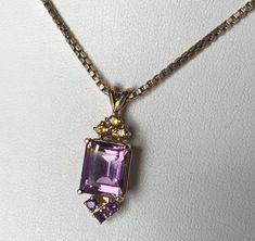 14k Gold Ametrine Amethyst Citrine Pendant Necklace 6.9gr 20" See Matching Ring 14k Gold Ametrine Amethyst Citrine Pendant Necklace 6.9gr 20" See Matching Ring Click images to enlarge Description  Offered here is a lovely 14k gold ametrine pendant necklace.  The pendant hangs from a substantial 20" box chain.  This was purchased with a "matching" ametrine ring, which I have listed separately, in case you were interested in a set. The ametrine is a combination of purple and golden yellow, but honestly has more purple than yellow (see photos).  It is 11 x 9 mm, approximately 4.20 ct in size, and set in a four-pronged head.  A trio of round citrines accents at top, and a trio of amethyst, at the bottom, to finish off the design.  Total carat weigh is about 4.62 ct. The chain is a 1.6mm 20-inc Ametrine Ring, Citrine Pendant, Matching Ring, Matching Rings, Fine Jewellery Necklace, Golden Yellow, Box Chain, 4 20, Monster High