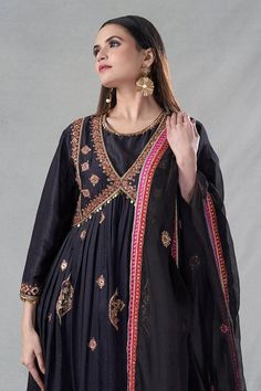 Black anarkali with metal sequin, zardozi, pitta, bead, nakshi, tassel, thread, resham embroidery. Paired with inner, cigarette pant and dupatta. - Aza Fashions Black Anarkali Salwar Kameez In Art Silk, Traditional Raw Silk Anarkali Set With Mirror Work, Diwali Kundan Embellished Embroidered Anarkali Set, Embroidered Black Art Silk Anarkali Set, Black Dola Silk Dupatta For Eid, Black Anarkali Set With Gota Work For Party, Party Anarkali Set With Gota Work In Black, Traditional Anarkali Set With Mirror Work For Transitional Season, Traditional Festive Anarkali Set With Dupatta