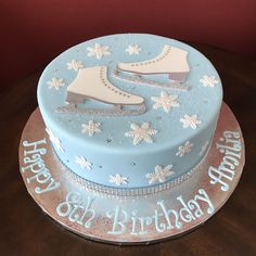 a birthday cake decorated with ice skates and snowflakes