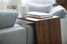 a close up of a table with a book on it and a cup sitting on top