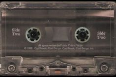 an old fashioned cassette tape with two black eyes on it's side and the word slide two written in white