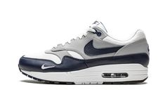 The Nike Air Max 1 LV8 “Obsidian” is a premium offering of the brand’s first-ever Air Max shoe. The alternate “LV8” (or "Elevate") version of the Air Max 1 is noted for its use of upgraded materials, and the “Obsidian” is a recipient of this redesigned look. A buttery cut of white tumbled leather forms the base of the upper, appearing on the toe, forefoot, and collar. Grey leather overlays contrast the look on the forefoot, mid-panel, and heel. An Obsidian leather Swoosh appears on either side o Nike Air Max Portal, Nike Air Max Obsidian, Dynamic Low-top Nike Air Max For Streetwear, Blue Nike Air Max For Streetwear, Blue Nike Air Max With Synthetic Material, Air Max One, Nike Trainers, Air Max Shoes, Fire Fits