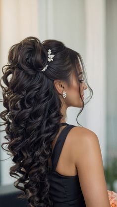 a woman with long hair wearing a black dress