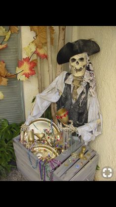 a skeleton sitting on top of a wooden crate next to a planter filled with items