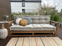 a couch sitting on top of a wooden floor next to a rug