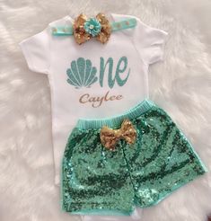 "This listing is for Under the sea inspired First Birthday outfit . Includes Bodysuit, Sequin Shorts and headband.Bodysuit used is carter's brand .It can be personalized with name Carter's Bodysuit is Crafted in babysoft cotton, Easy to change with Nickel-free snaps on reinforced panels . Perfect for first birthday/cake smash Birthday number color can be changed , please message me prior to purchasing to see if I have your color option available! To personalize your order please leave a note upo Oneder The Sea 1st Birthday Outfit, Mermaid First Birthday Outfit, One Year Old Mermaid Birthday Outfit, Under The Sea Birthday Shirt, 1st Birthday Under The Sea Theme, Under The Sea Birthday Party Outfit, Under The Sea Birthday Outfit, First Birthday Mermaid, First Birthday Sea Theme