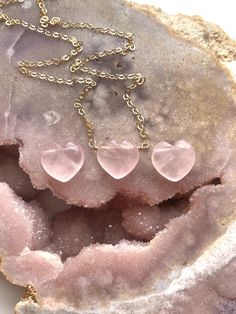 A beautiful heart shaped Rose quartz Crystal has been made into a pendent and placed on a delicate Sterling silver or 14k gold filled chain. 10mmThese rose quartz necklaces are so soft and feminine- with loving calm energy emitting from each stone, and speaking directly to your heart chakra-this will make the perfect addition to you jewelry collection. Handcrafted Raw Rose Quartz Pendant Necklace• Beautiful Raw Crystal jewelry gift • Inspires Love • High quality genuine rose quartz • Raw stones offer stunning unique characteristics• Your choice of chain — sterling silver or 14k gold• Choose the length you’d like — 16, 18, or 20"• Delivered in a luxurious pink velvet jewelry bagUNIQUELY YOURS Your necklace will be made to order and will look similar to the photo above. Because it’s one-of-a Raw Rose Quartz Necklace, Pink Crystal Necklace, Rose Quartz Pendant Necklace, Calm Energy, Rose Quartz Necklace Pendants, Dainty Rose, Heart Necklaces, Quartz Pendant Necklace, Rose Quartz Jewelry