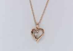 Cherish the elegance of our 14K Rose Gold Heart Pendant, gracefully adorned with .03 carats total weight of Lab Diamonds, accompanied by an 18" Chain. This exquisite piece is skillfully handcrafted by our artisanal goldsmith at Jewelry By You. Elegant Formal Heart Necklace With Birthstone, Rose Gold Heart Pendant Necklace With Diamond Cut, Rose Gold Diamond Necklace For Anniversary Gift, Elegant Rose Gold Heart Necklace With Diamond Cut, Elegant Rose Gold Diamond Cut Heart Necklace, Rose Gold Diamond Cut Necklace For Anniversary, Rose Gold Diamond Heart Necklace With Brilliant Cut, Fine Jewelry Single Diamond For Valentine's Day, Rose Gold Jewelry With Diamond Accents For Anniversary