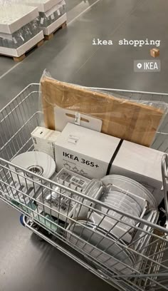 a shopping cart filled with boxes and plates