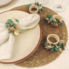 a place setting with napkins and flowers on it