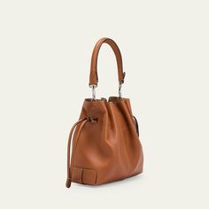 Tod's "Di" bucket bag in soft full grain leather  Detachable tubular top handle  Detachable, adjustable crossbody strap Can be worn as a top handle or crossbody bag  Drawstring closure  Distinctive Tod's logo stamped on the front Lining: Leather Approx. 6.6"H x 7.8"W x 3.9"D Made in Italy Leather Bucket Satchel For On-the-go, Luxury Bucket-shape Shoulder Bag For On-the-go, Cognac Bucket Bag For On-the-go, Leather Crossbody Bucket Bag For On-the-go, Classic Calf Leather Bucket Bag For Everyday Use, Soft Calf Leather Bucket Bag With Top Handle, Everyday Calf Leather Satchel With Adjustable Strap, Everyday Cognac Bucket Bag With Detachable Strap, Classic Leather Bucket Bag With Double Handle