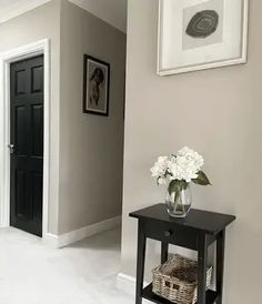 a hallway with white floors and gray walls