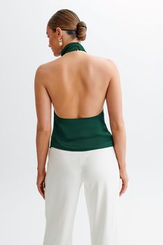 Elevate your everyday.Introducing the SERAPHINE Satin Halter Top, a vision of elegance and allure. Crafted to perfection, this top features a stunning halter neckline adorned with a graceful cowl detail, adding a touch of sophistication to your look. The low back design exudes understated glamour, while the asymmetrical hemline adds a modern twist. Complete with a delicate button closure at the neckline, it ensures a secure and stylish fit. Lined for comfort and coverage, this top promises a lux