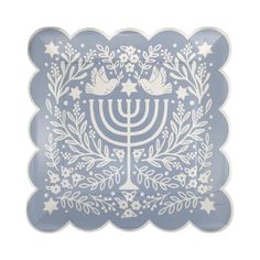 a blue and white plate with a menorah design on the front, surrounded by stars