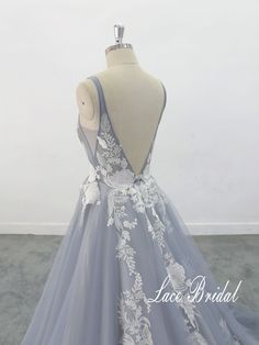 a dress on a mannequin with white flowers