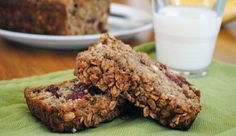 three granola bars stacked on top of each other next to a glass of milk