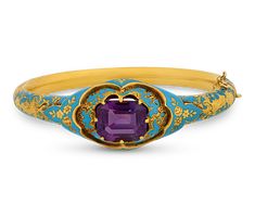 This exquisite Victorian bracelet, once owned by Elizabeth Taylor, showcases a striking 7.25-carat amethyst set in 18K yellow gold, enhanced by delicate blue enamel inlay. The vibrant purple hue of the amethyst, paired with the rich, deep blue enamel, creates a stunning visual contrast that epitomizes Victorian elegance. The craftsmanship of this bracelet reflects the intricate design and attention to detail characteristic of the era, while its provenance as part of Elizabeth Taylor's famed jewe Who's Afraid Of Virginia Woolf, Elizabeth Taylor Jewelry, Victorian Elegance, Victorian Bracelet, Extraordinary Jewelry, Amethyst Set, 18k Gold Bracelet, Tin Roof, Virginia Woolf