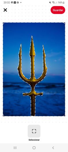 an image of a yellow anchor in the ocean with blue sky and water behind it