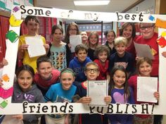 a group of children holding up signs in front of them