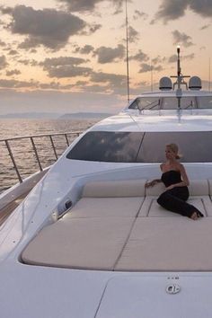 a woman sitting on the back of a boat