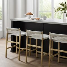 three stools sitting in front of a counter top