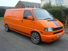 an orange van parked in front of a house