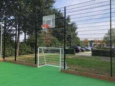 an outdoor basketball court with a goal and net