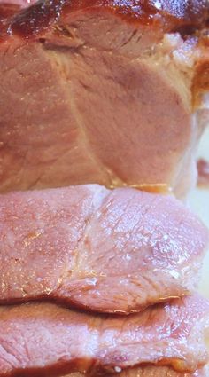 closeup of raw meat being cut into pieces with the skin still attached to it