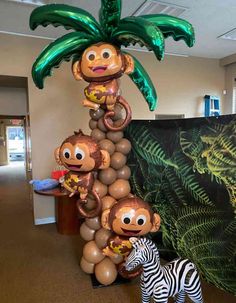 some balloons are stacked on top of each other in the shape of monkeys and zebras