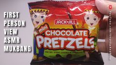 a person holding up a bag of chocolate pretzels