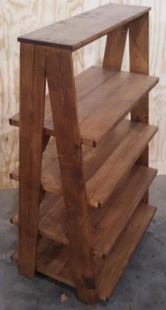 a wooden shelf sitting on top of a cement floor