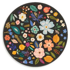 a black plate with colorful flowers and leaves on it