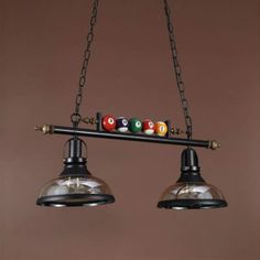 two lights hanging from the ceiling with billiard balls on them and one light is turned on