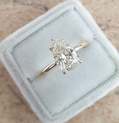 a diamond ring sitting on top of a white cloth