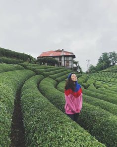 a woman standing in the middle of a maze