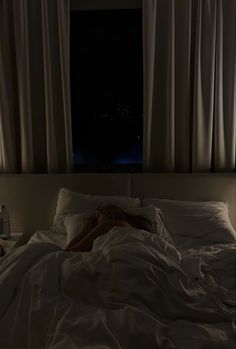 a person is laying in bed at night