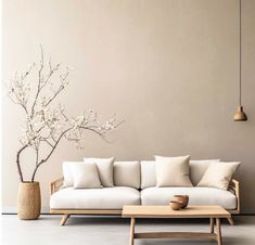 a white couch sitting next to a wooden table